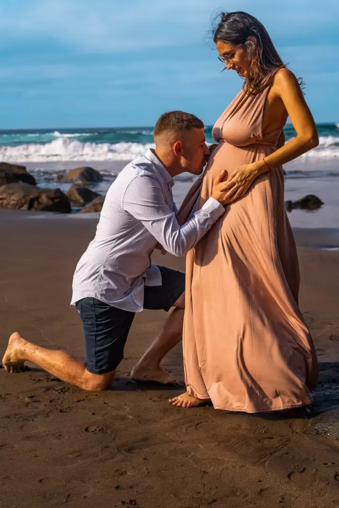Future parents sharing a joyful moment on the dunes of Gran Canaria