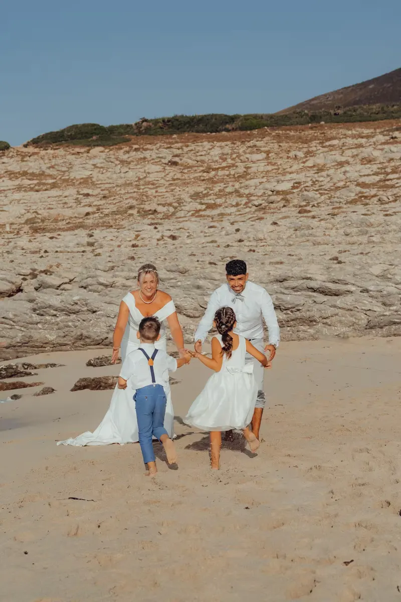 Bride and groom laughing together on a wooden pier over the turquoise water