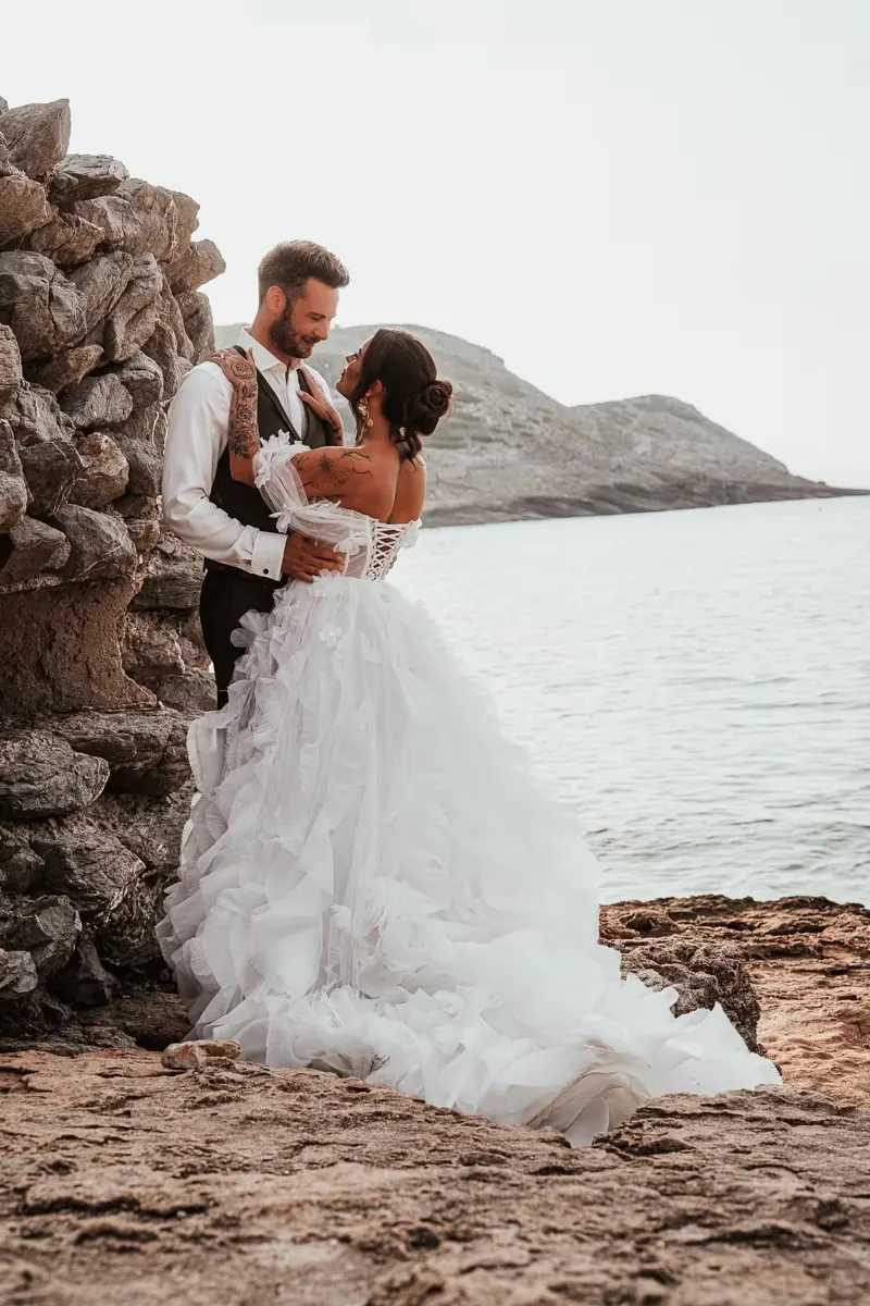 Couple embracing during golden hour on the cliffs of Mallorca