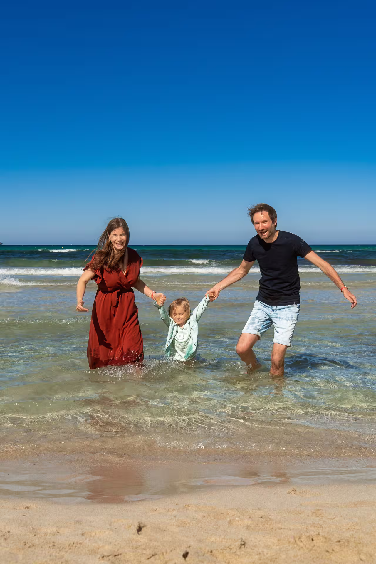 Young family in the sea at Alcudia