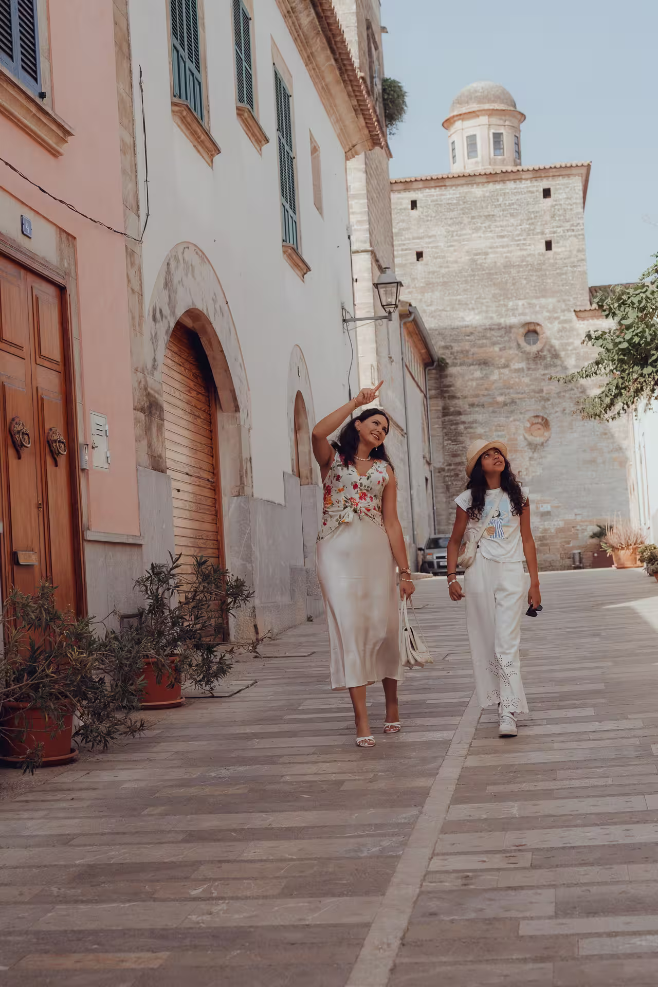 Mother and daughter walking through the lanes of Alcudia