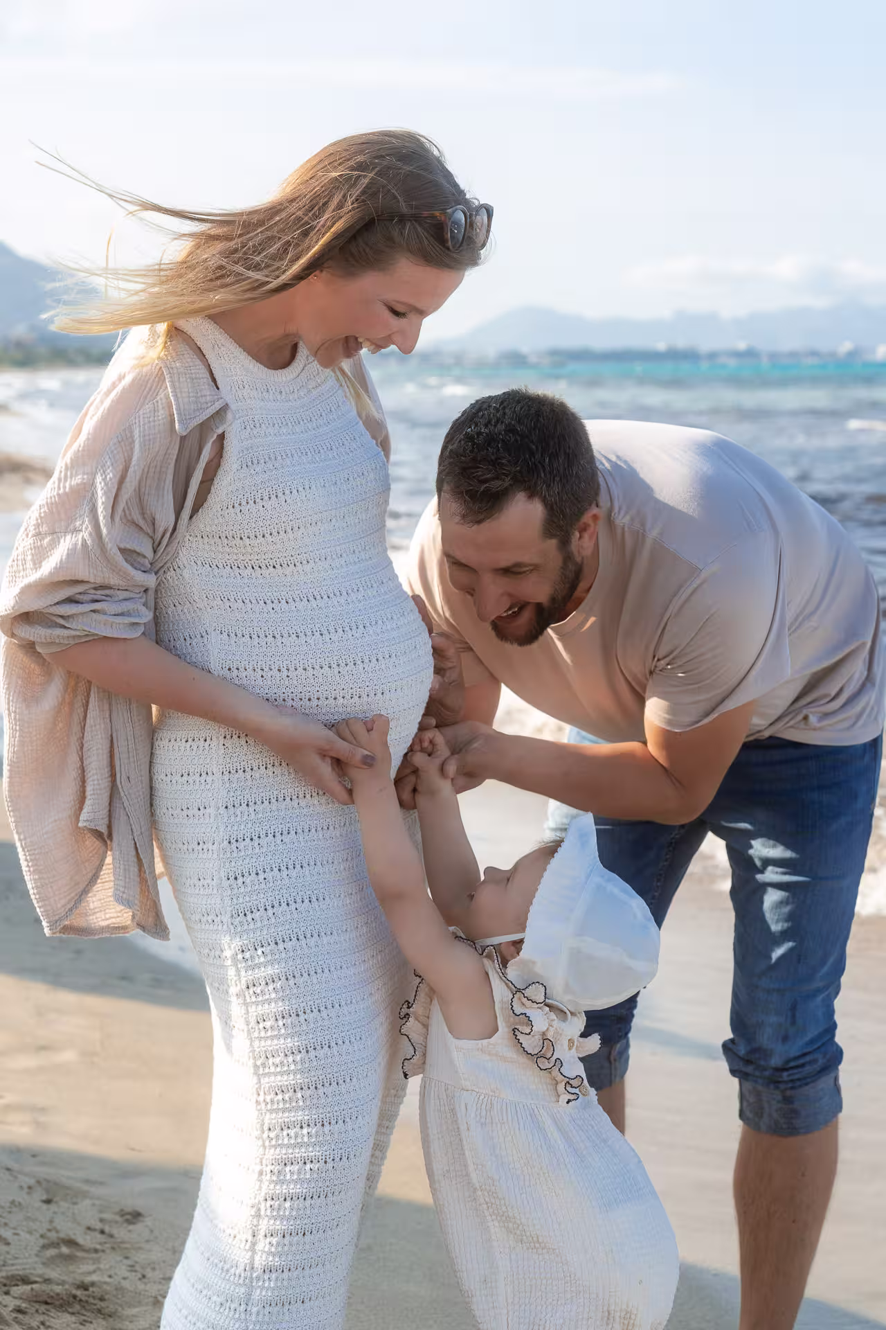 Mother-to-be sitting on sun-drenched stone steps in a picturesque Mallorcan village