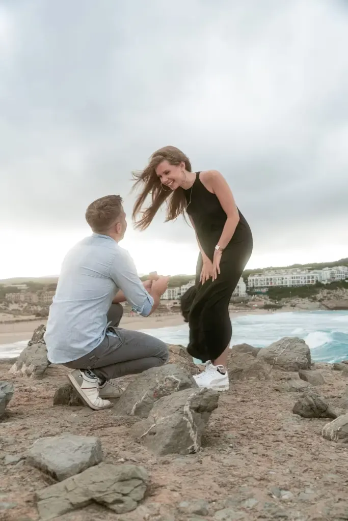 Proposal on a rock on the beach in Mallorca under a cloudy sky