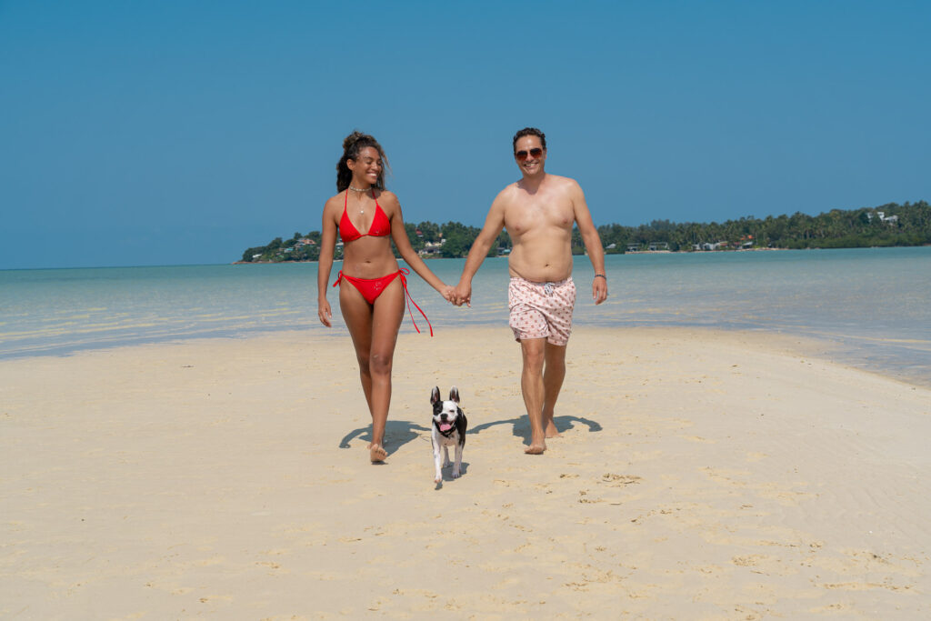 Thailand holiday photo shoot with dog – couple laughing on the beach