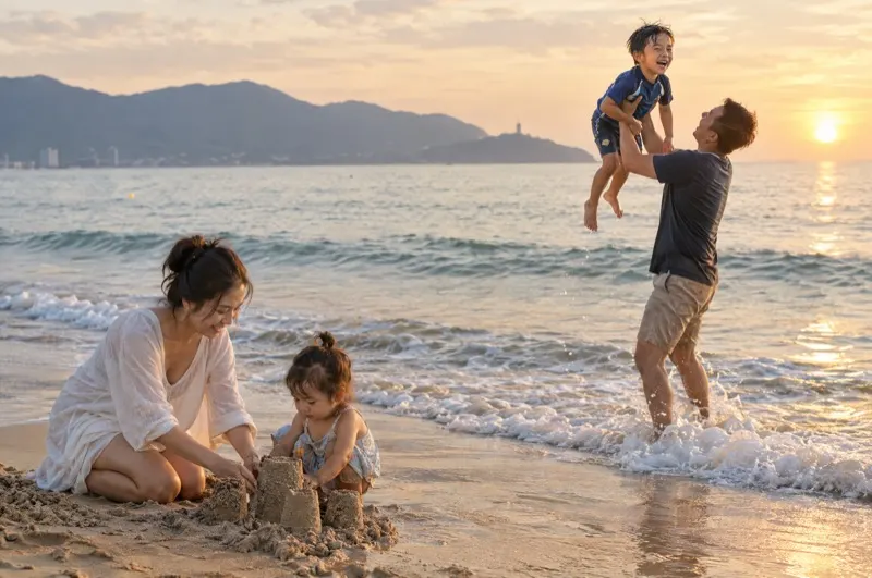 Family photoshoot in Da Nang – father lifting his son above the waves on My Khe Beach